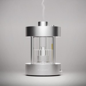The Transparent diffuser is aluminum, glass and round, on a neutral background