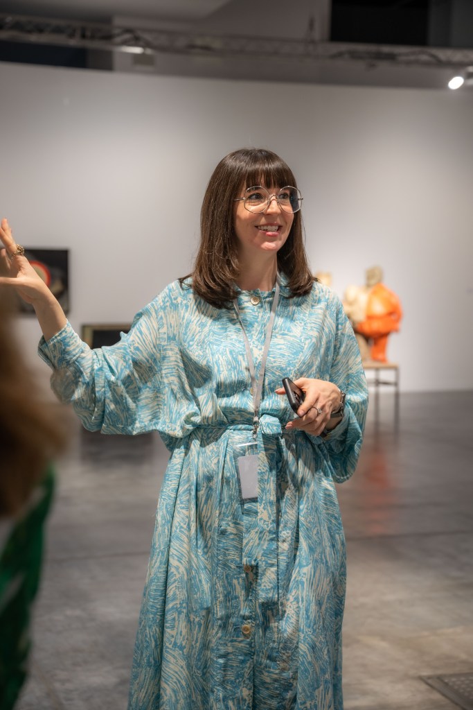 Bridget Finn speaks to guests at Art Basel Miami Beach.