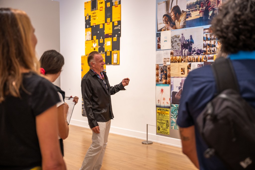 Artist Jack Pierson speaking to a group of people about his work at The Bass Museum of Art in Miami.