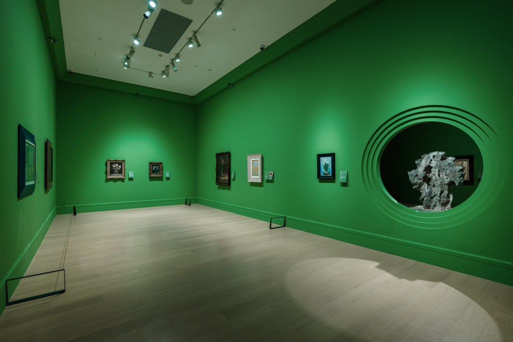 A green gallery room of flower-themed artworks at the Deji Art Museum.