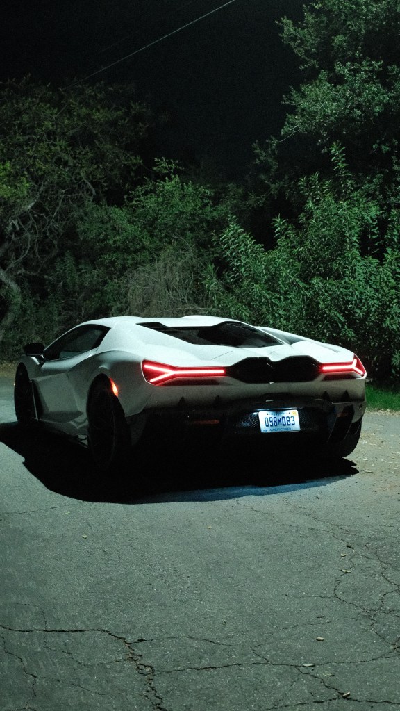 A white Lamborghini Revuelto shot from the back.