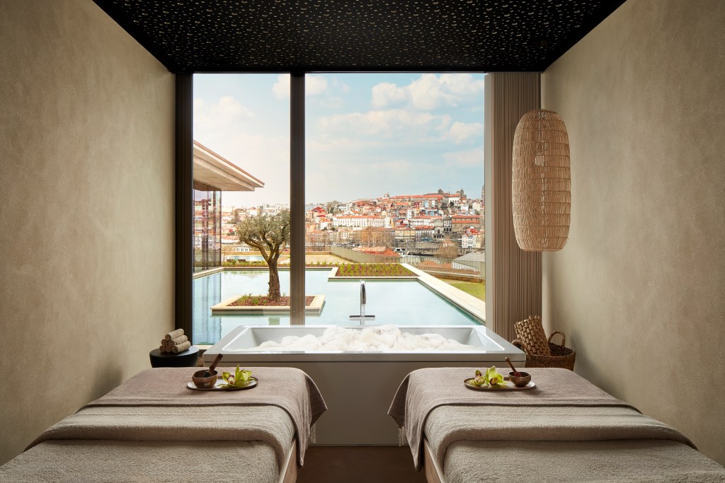 A couples treatment room at the spa, overlooking the outdoor pool, at the Tivoli Kopke Porto Gaia Hotel.