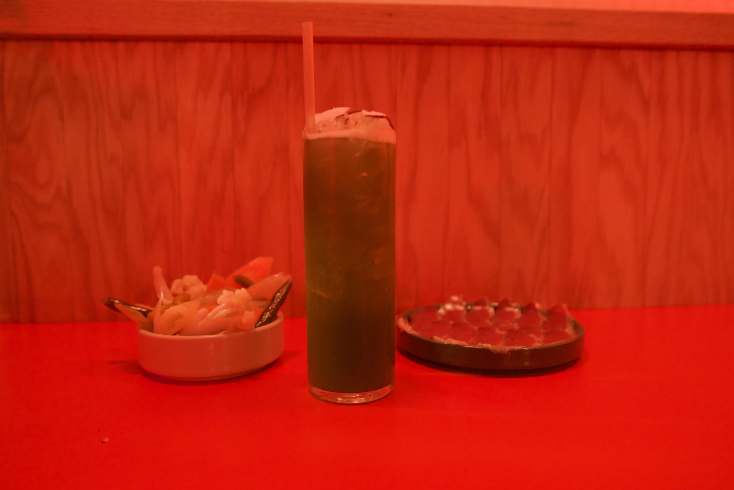 A cocktail sitting on a table at Cents Pizza.