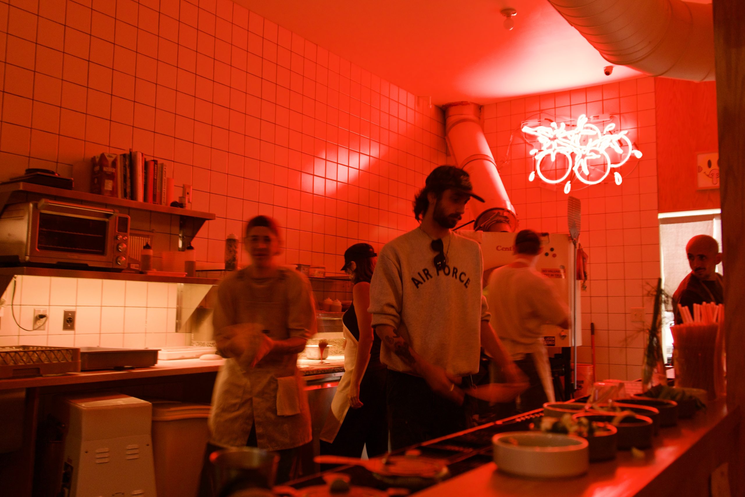 Employees in the open kitchen at Cents Pizza.