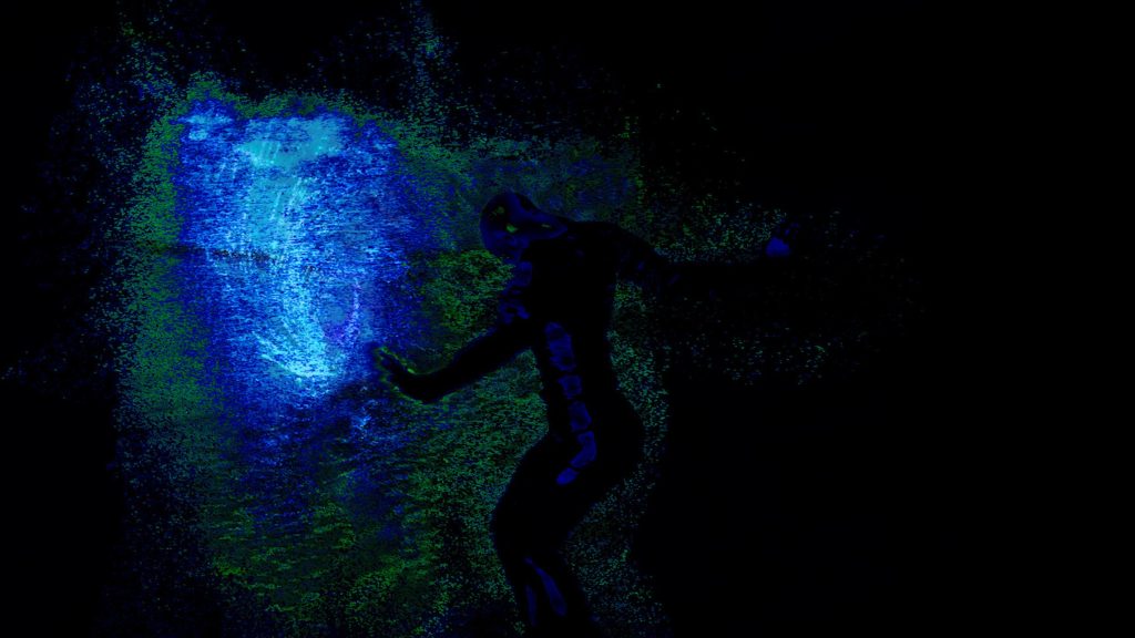 A dark background with a growing blue shape and a abstract green figure moving.