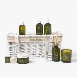 A collection of Bamford geranium products in a reusable gift hamper on a plain background