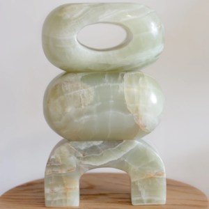 A marble sculpture with three stacked organic forms