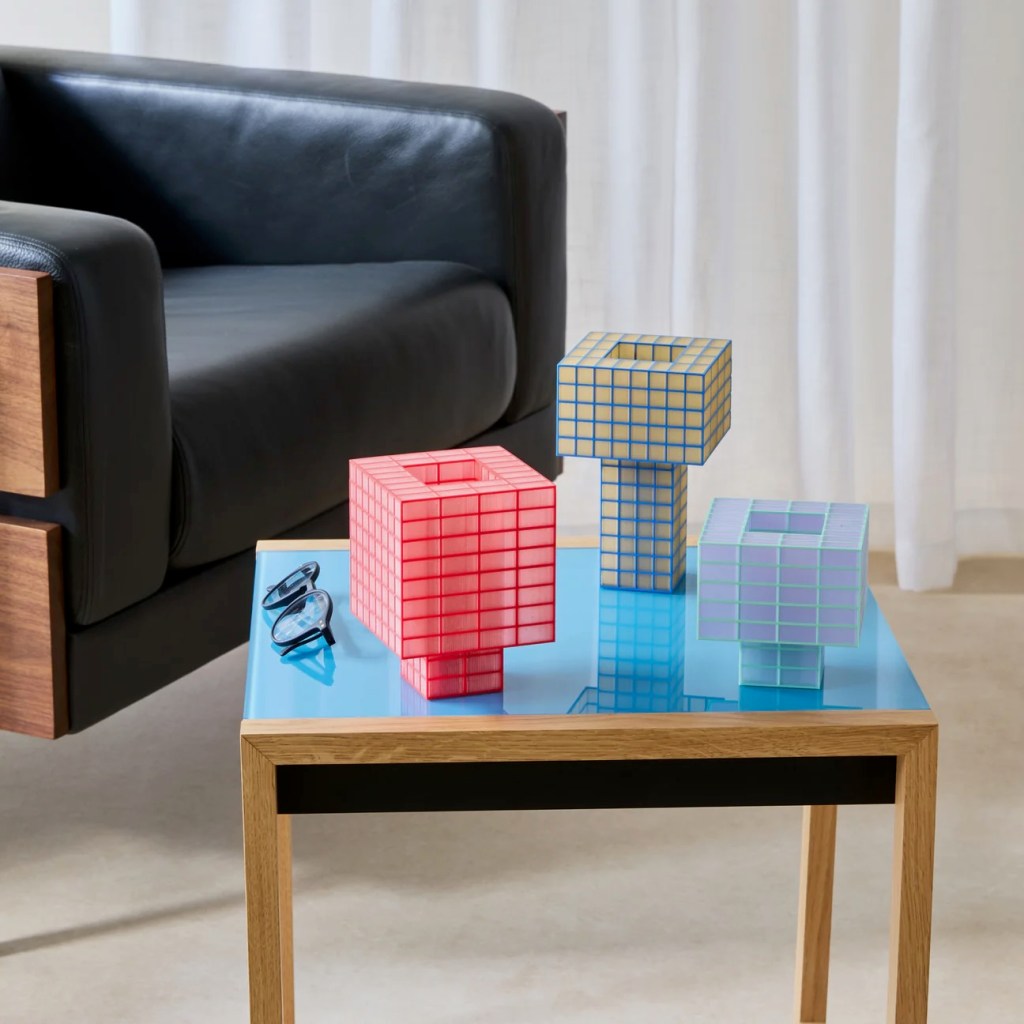 Three Tesser lights in different colors and sizes on a table