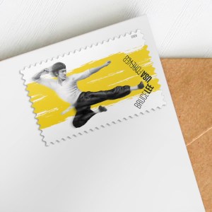 A USPS Bruce Lee stamp shown close up on an envelope