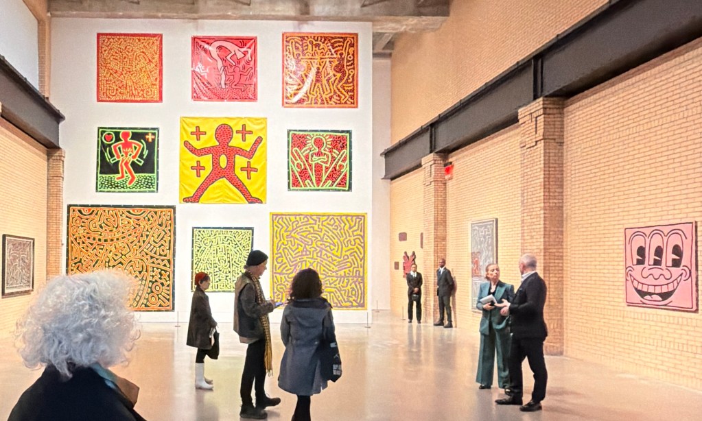 Large tarp works and iconic paintigs are shown in the Keith Haring show's primary room