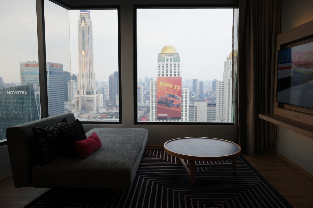 A view of Bangkok skyscrapers shot out of a Moxy Bangkok guest room window.