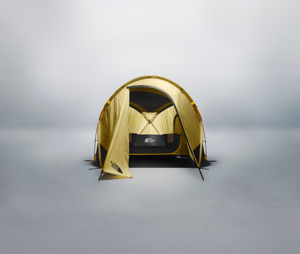 A light yellow The North Face Wawona 3 tent, fully assembled, with an open door on a gray background.