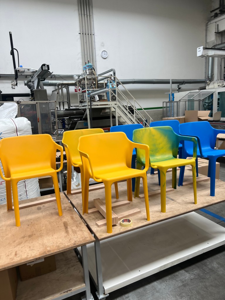Seven Linnea chairs sitting on a table in the factory.