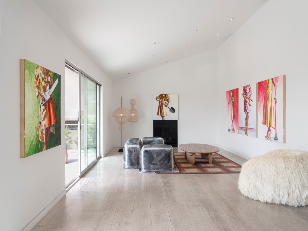 An installation view of Kelly Reemsten's "Fool's Gold" show at Albertz Benda Gallery with gold dress paintings on the wall and sculptural furniture in the room.