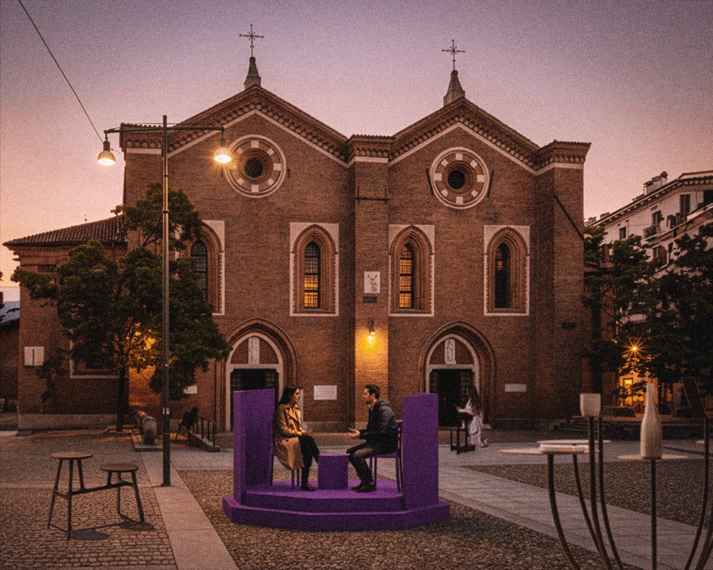 A couple sits at a purple installation in front of a church