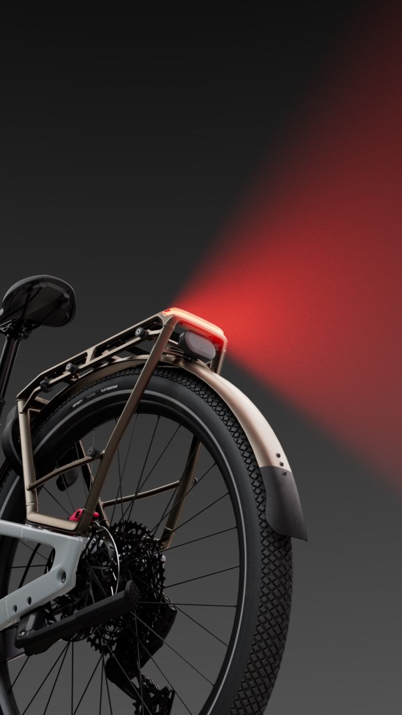 A detail of a red tail light on the back of a Specialized Vado 3 EVO bike.