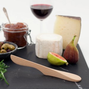 A Bosign AirSpreader in beech on a platter with fruit and cheese and a glass of wine