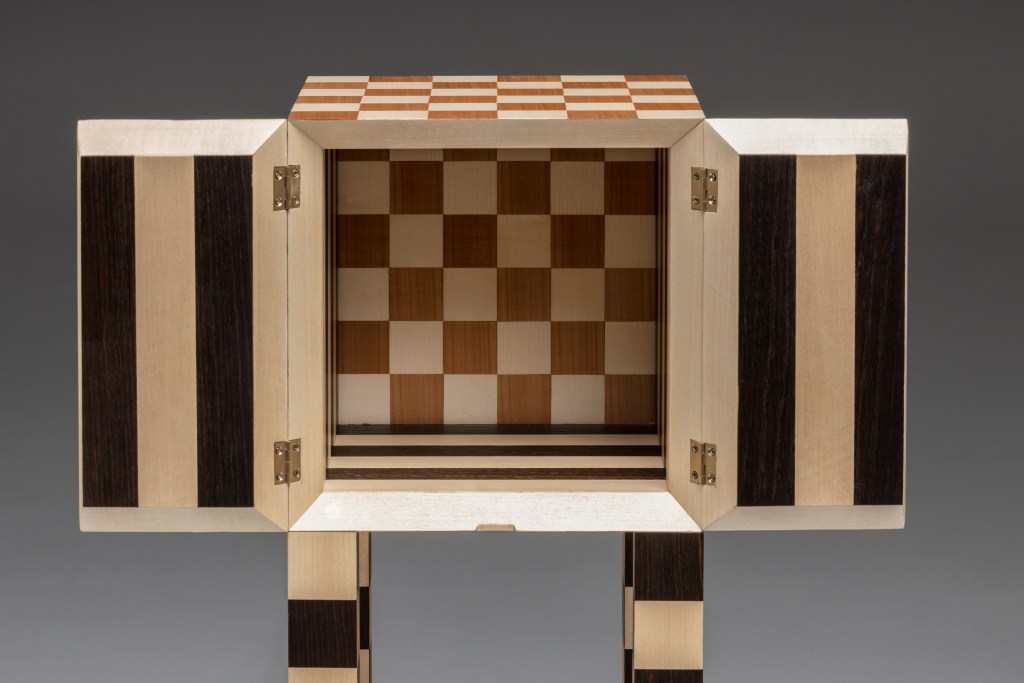 a wooden cabinet features geometric patterns