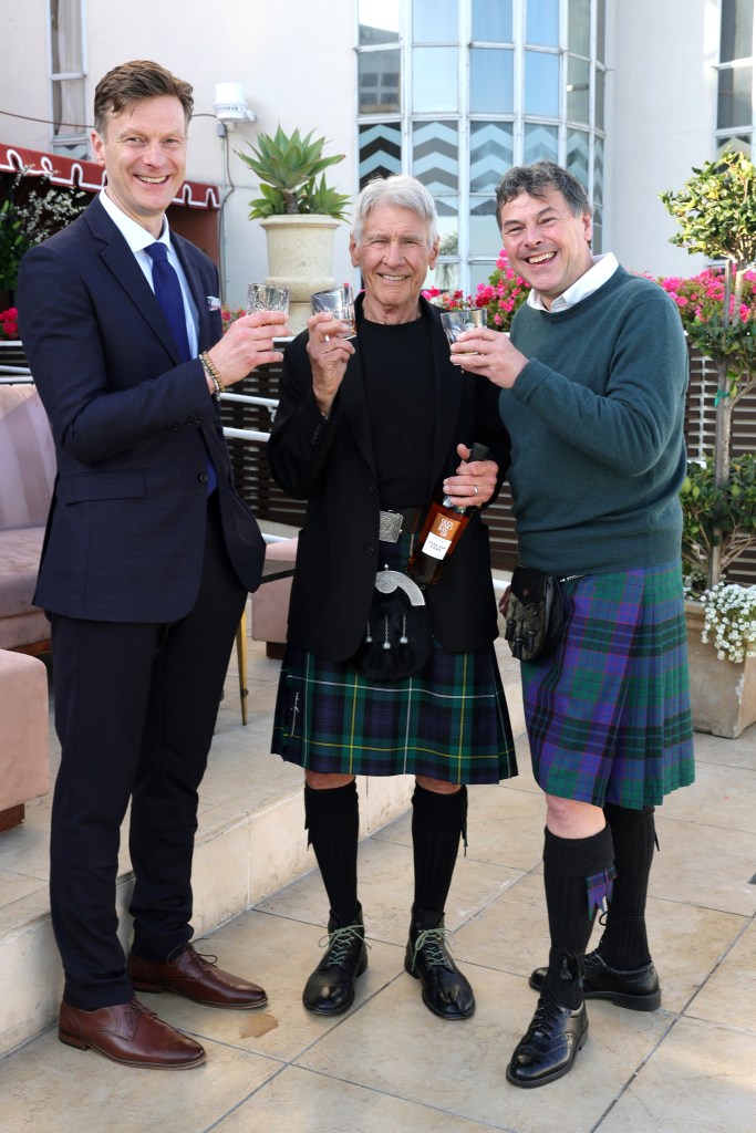 CEO President at The Glenmorangie Company Caspar MacRae, Harrison Ford and Dr. Bill Lumsden standing on the patio at the Sunset Tower Hotel in West Hollywood.