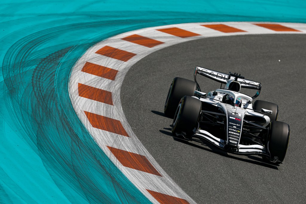 An F1 Team Cadillac car driving on the curve of a track in MIami.