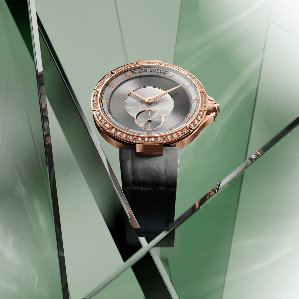 A Roger Dubuis Excaliber Lady of the Lake watch shot on a green paper background with layers of clear glass overlapping it.