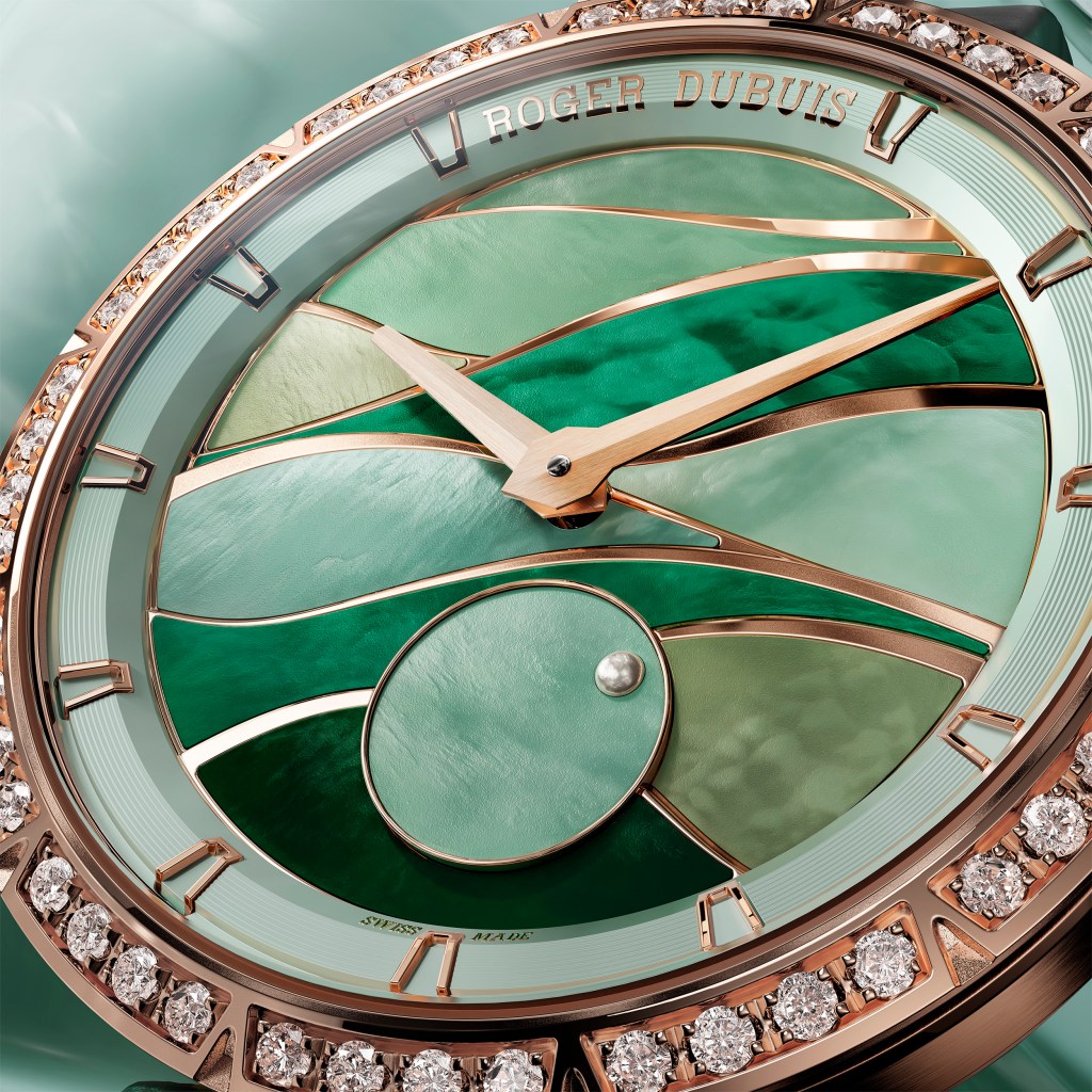 The watch face of a Roger Dubuis watch with different shades of green mother of pearl.