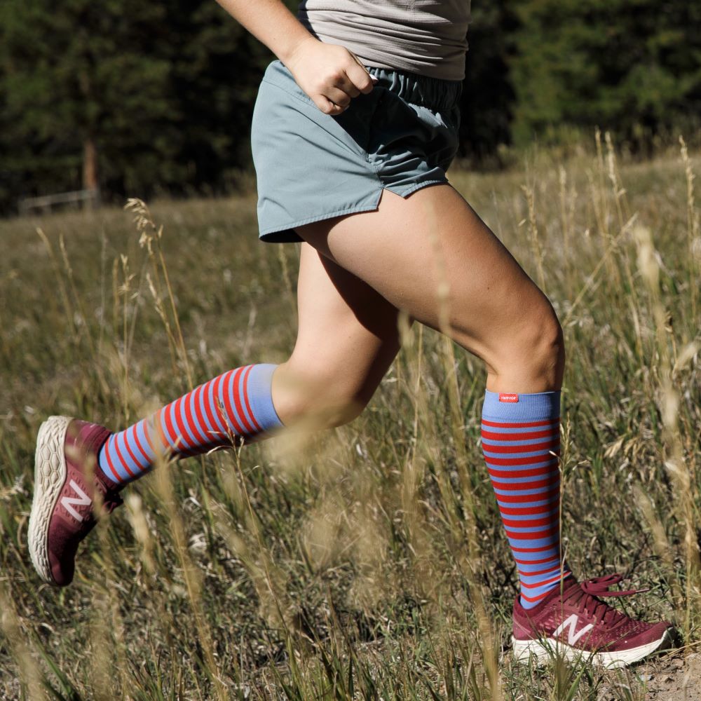 VIM & VIGR compression socks on a person running, in the falling stripe pattern