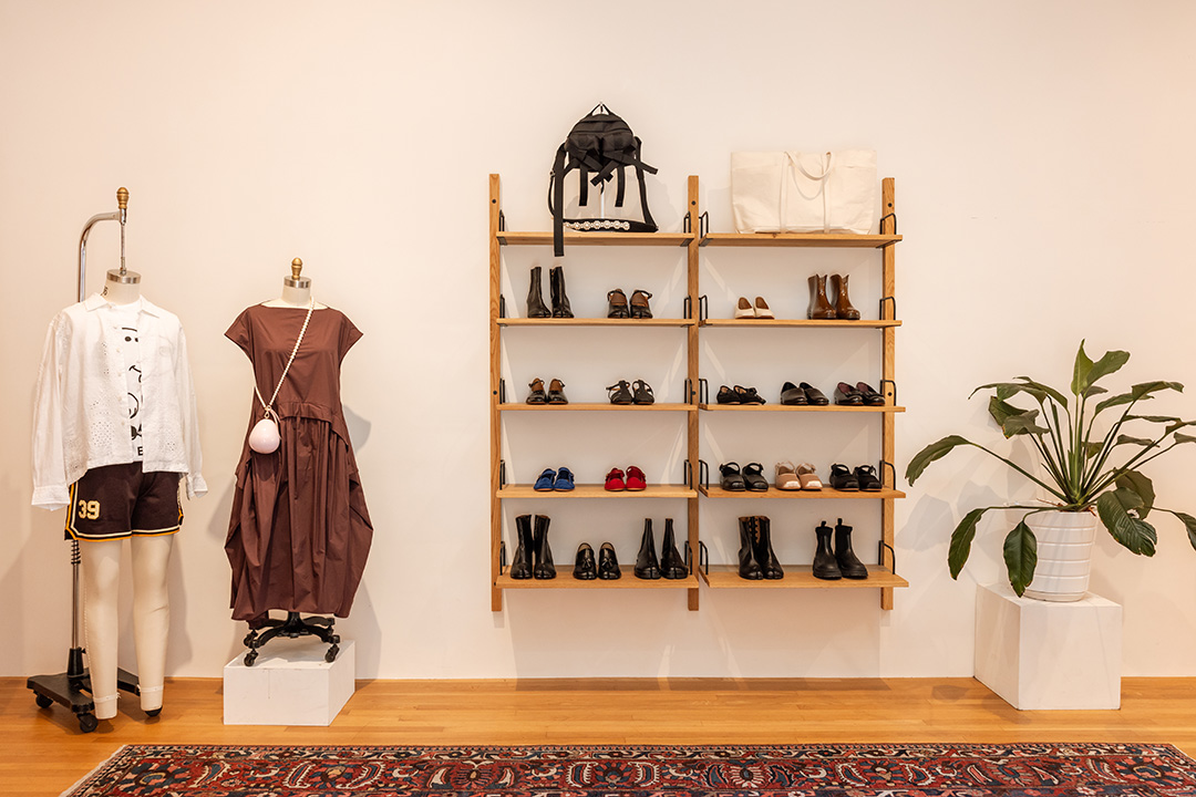 A display at Frances May with a brown dress and a hanging rack of shoes.