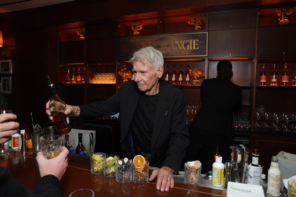 Harrison Ford behind the bar at the Sunset Tower Hotel, serving his Glenmorangie limited edition single malt scotch.