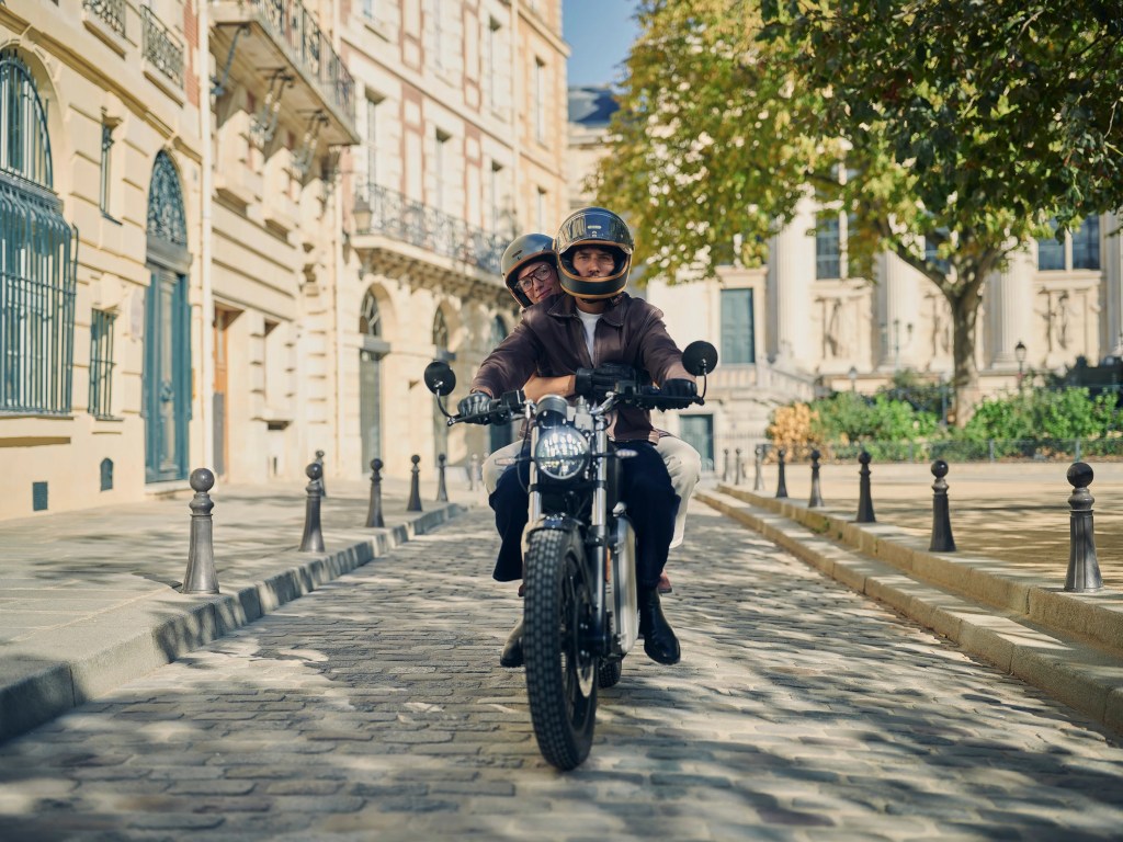 A couple riding the Maeving RM2 down a Parisian street.