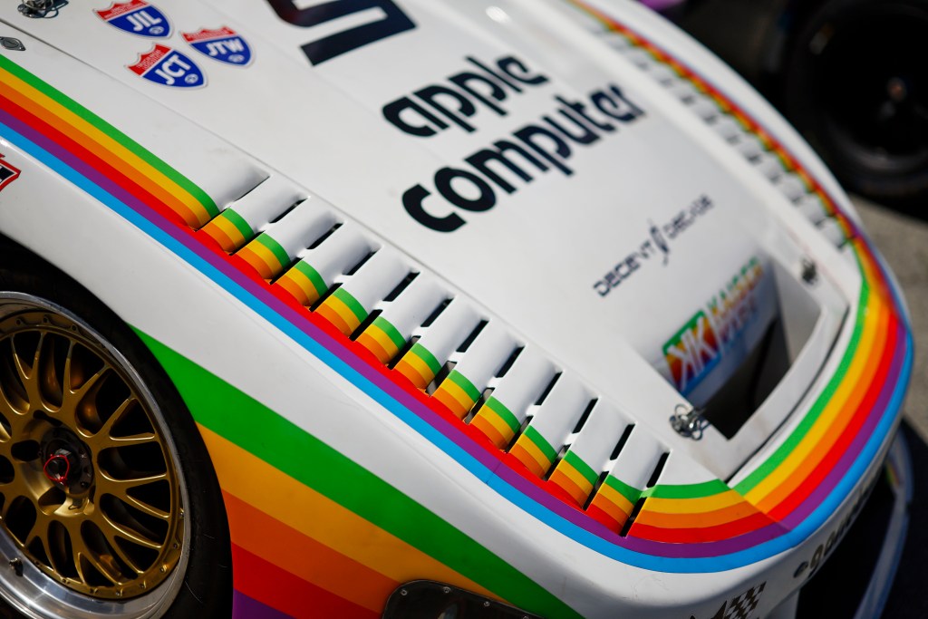 A detail of the vintage Apple Computer graphics on the vents of a Porsche racecar at IMSA Monterey SportsCar Championship 2026.