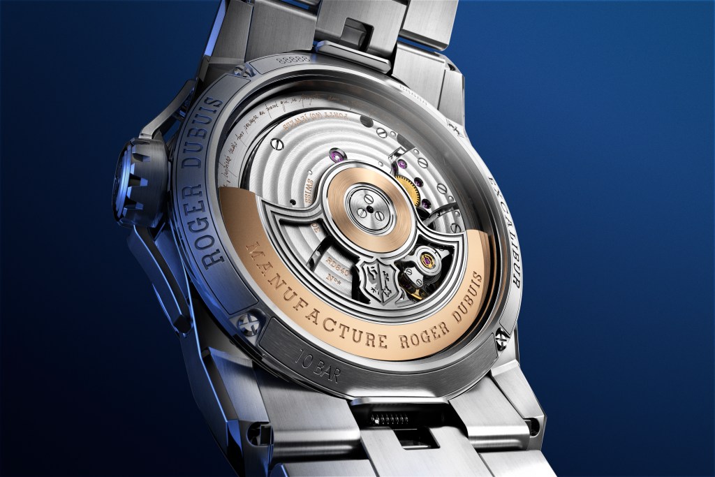 The underside of a steel Roger Dubuis watch on a dark blue background.