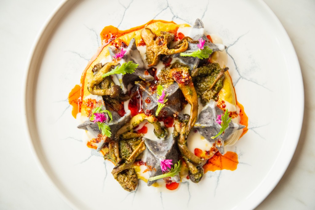 A colorful plated meal from Bellpine shot overhead on a white plate.