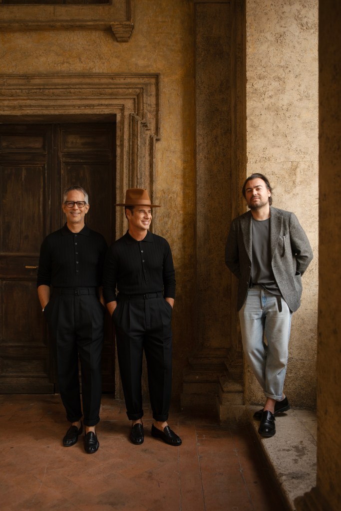 Robert Onuska, Nacho Polo and Francesco Balzano standing in front of a stone wall and doorway.
