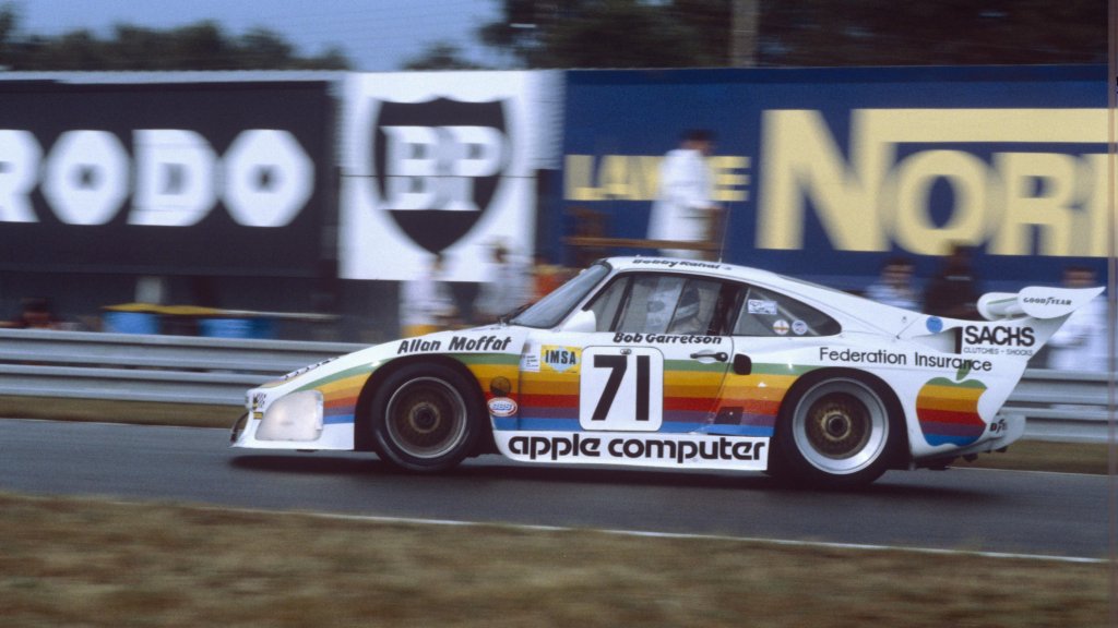 An archival photo of a racecar from the 1980s with Apple Computer graphics on the side.