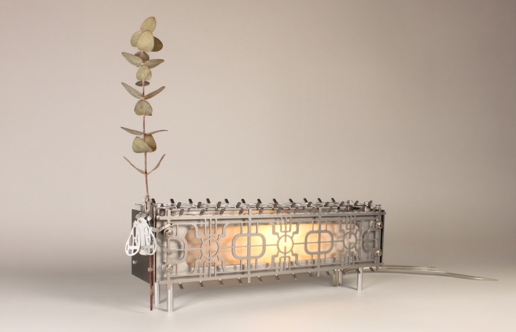 Porch Time by Bechara Maalouf is an illuminated console with a metallic branch growing out of it