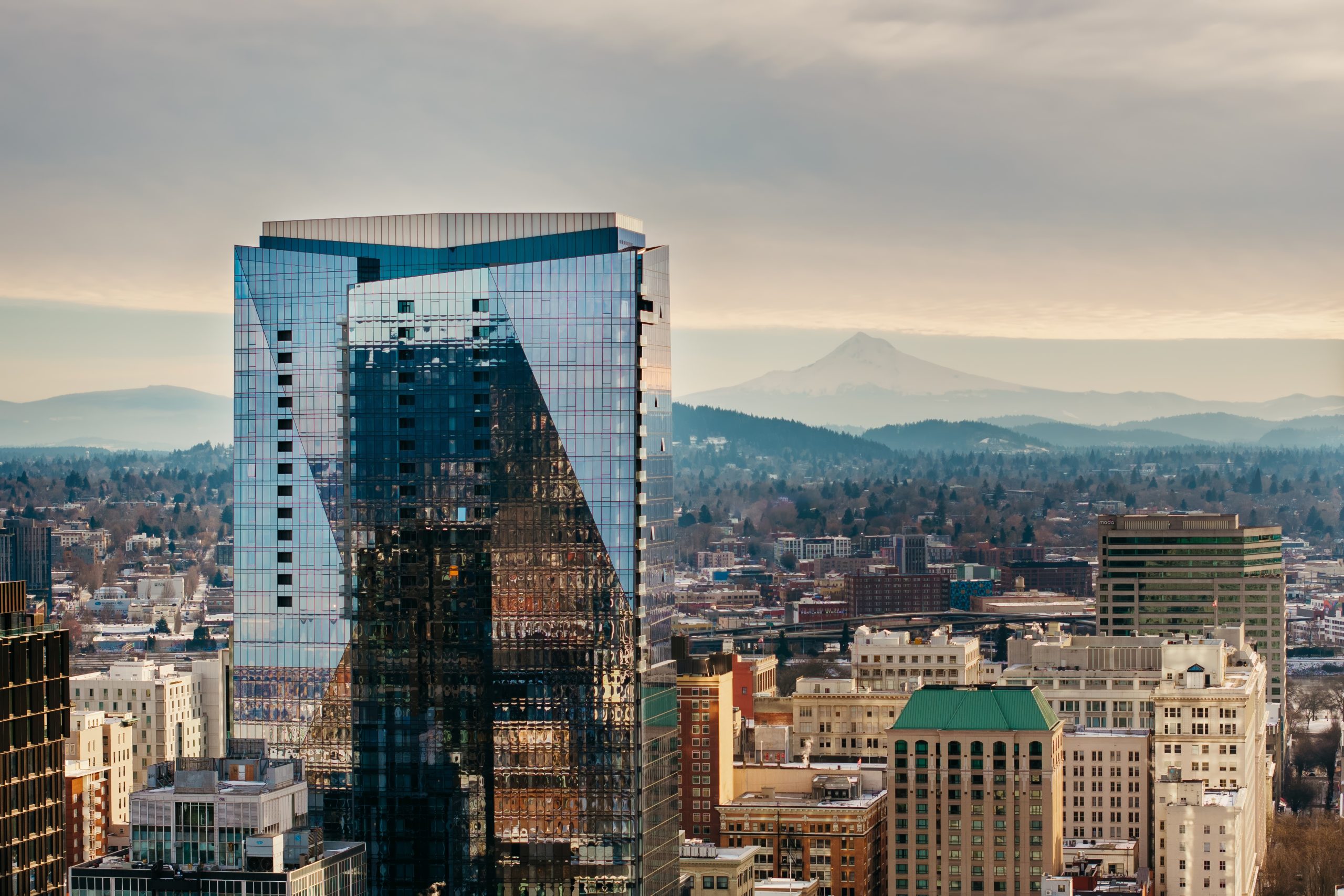 An exterior view of The Ritz-Carlton, Portland with a view of Mt Hood in the background.