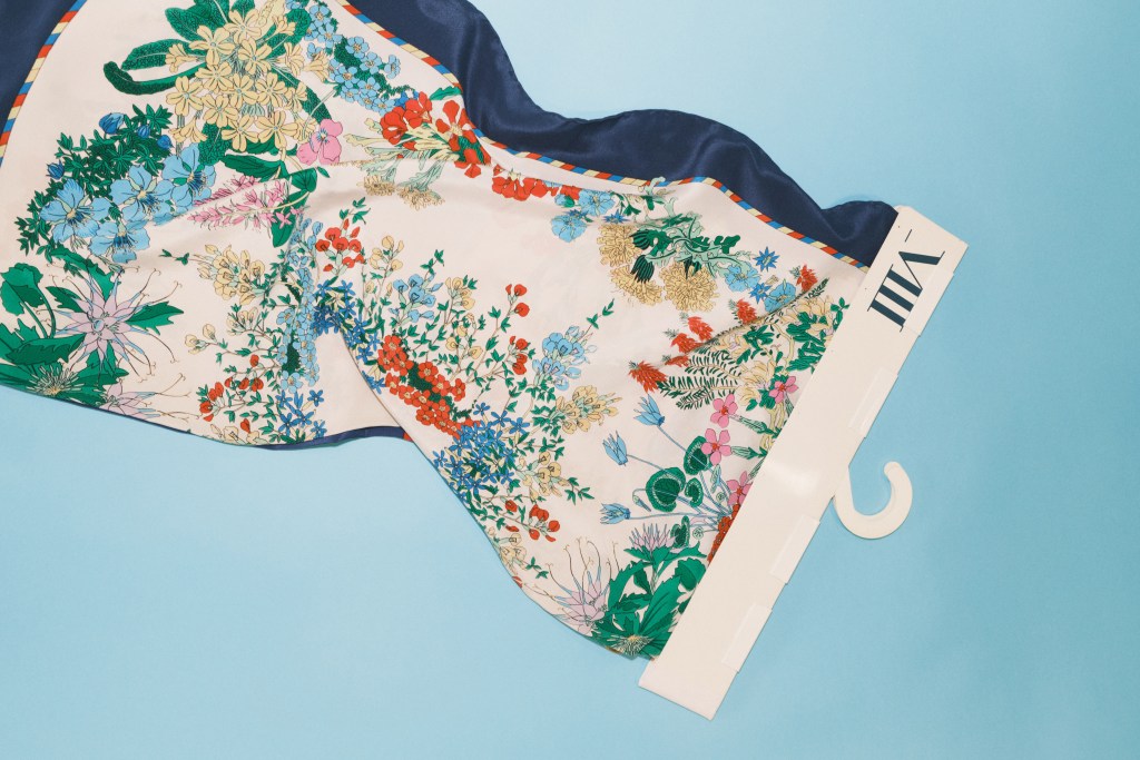 An archival floral fabric sample by Mantero Seta on a light blue background.