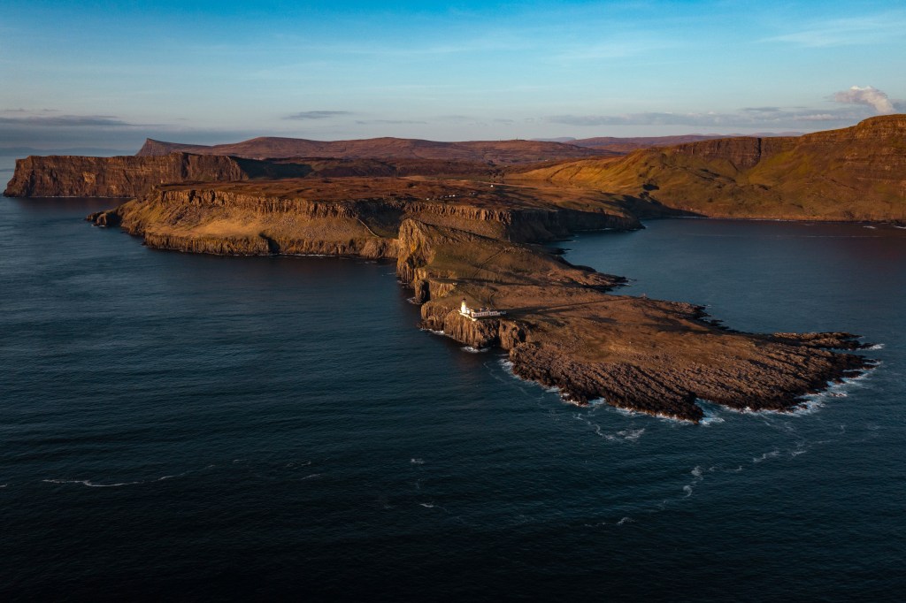 An aerial view of the Isle of Skye on a sunny day with a blue sky.