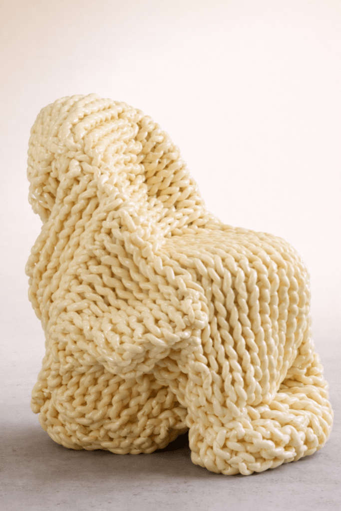 A pale yellow sculptural chair by Kwangho Lee sits on a neutral white background.