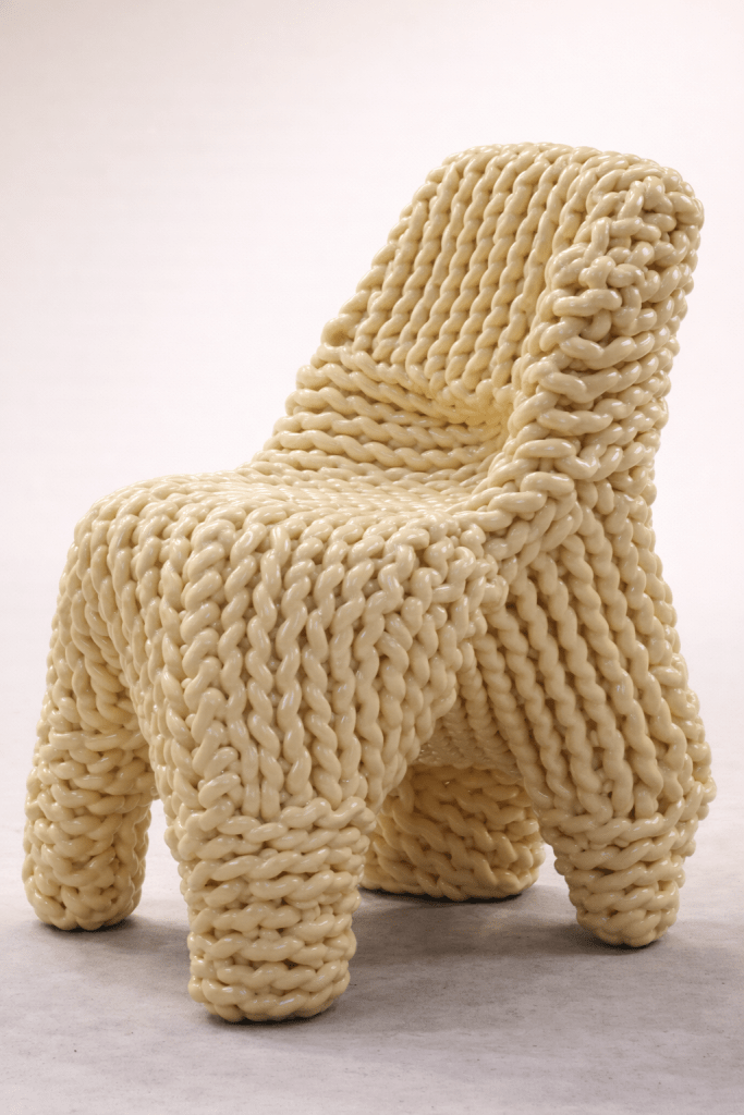 A pale yellow sculptural chair by Kwangho Lee sits on a neutral white background.