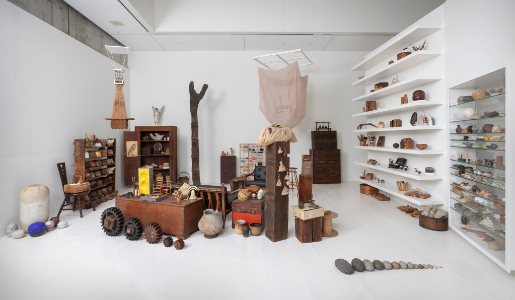 A white gallery space filled with artworks and collectible items of Lenore Tawney.