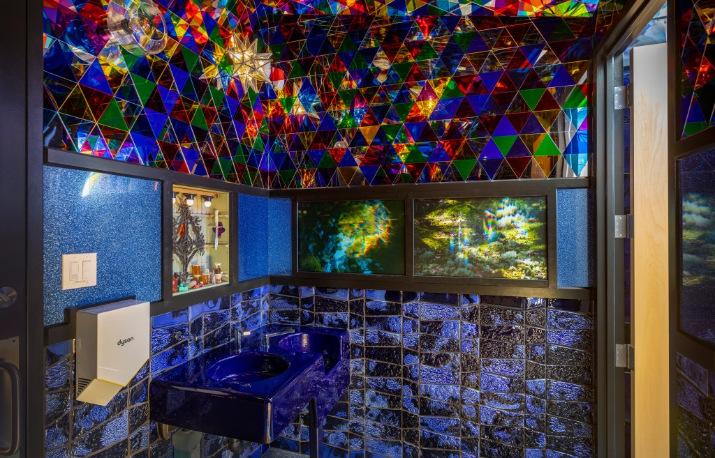 A blue and black bathroom with a multi-color ceiling at John Michael Kohler Art Preserve.