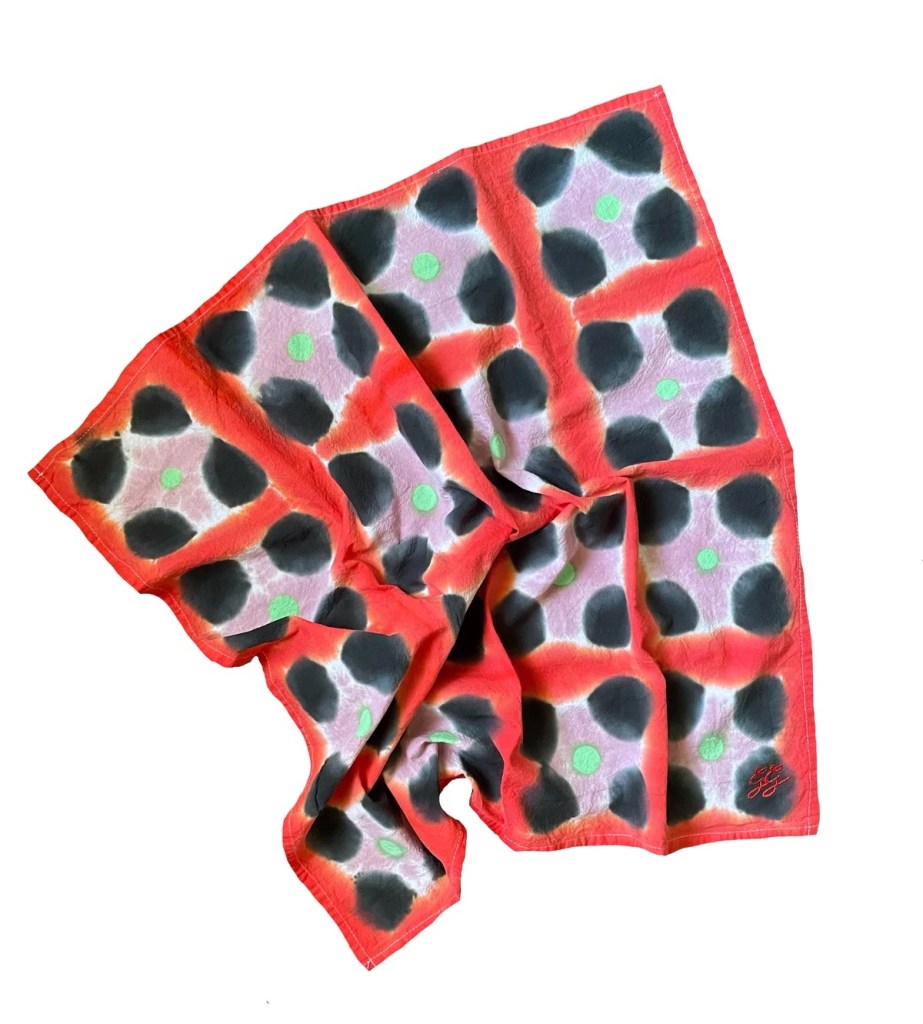 A colorful kitchen towel hand dyed with a pattern