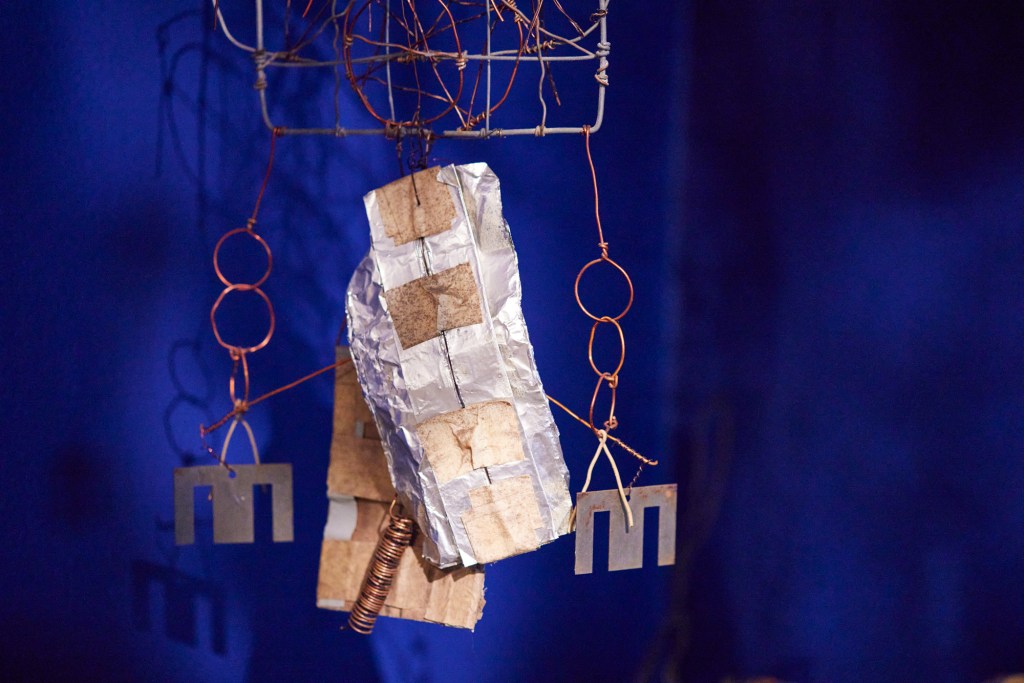 A detail of Emery Blagdon's "The Healing Machine" shot on a blue background.