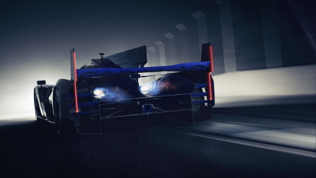 The Cadillac V-One Concept Car shot from the back as it drives away on a dark test track.