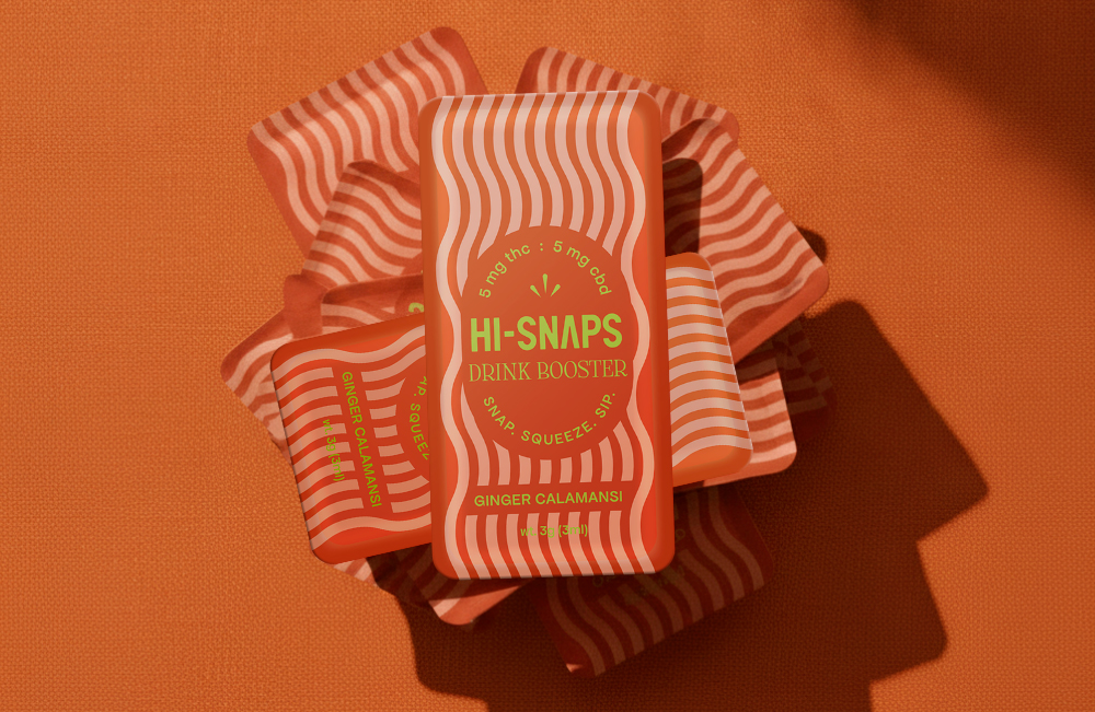 A rusty orange background with a stack of Ginger Calamasi Hi-Snaps shot overhead with a dramatic shadow.