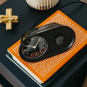 Black alarm clock on orange book