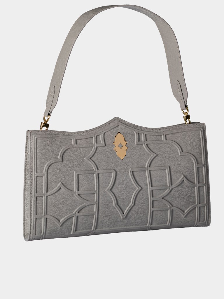 A gray Dellaluna Louvre Abu Dhabi bag with the strap up, shot on a white background.