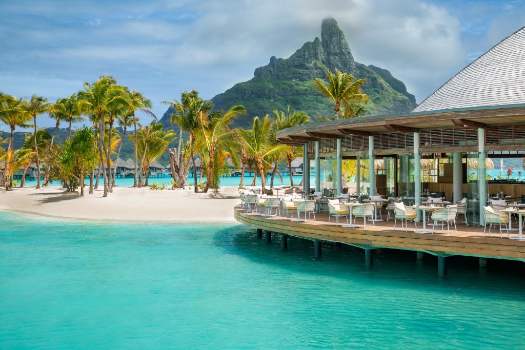 An exterior view of a open-air restaurant above the water at The Westin Bora Bora.